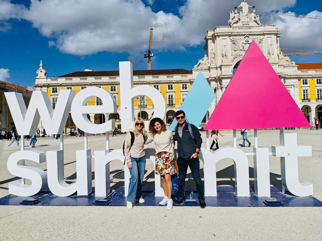 entrapeer team in front of the web summit lisbon sign